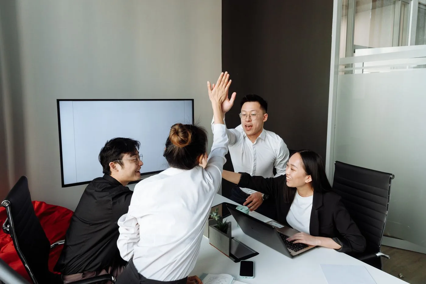 A team celebrating together in a modern office
